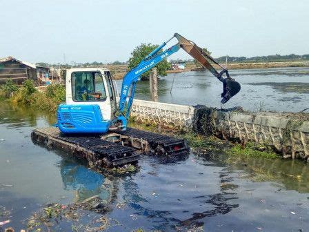 An Excavator Is In The Middle Of Water