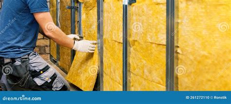 House Wall Insulation Construction Worker Installing Glass Wool Into The Metal Profile Frame