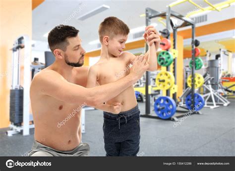 Father and son in gym — Stock Photo © belchonock #155412286