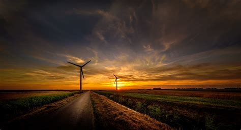 Download Field Sky Sunset Horizon Landscape Man Made Wind Turbine 4k Ultra Hd Wallpaper