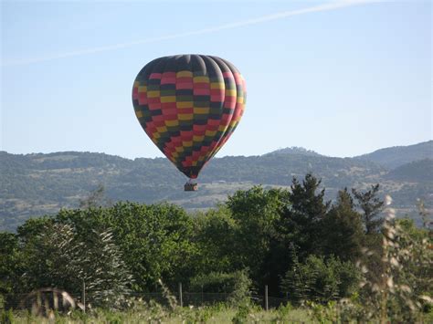 Colorful Hot Air Balloon Flying Over Trees