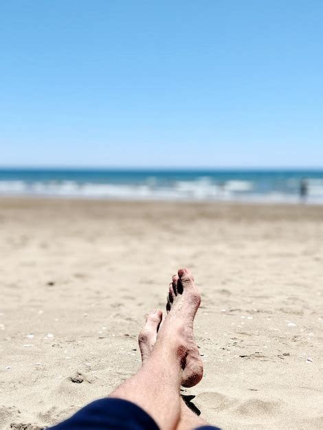 Premium Photo Low Section Of Person At Beach