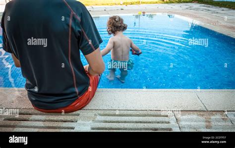 A Father Is Surveilling His Son At The Swimming Pool To Prevent