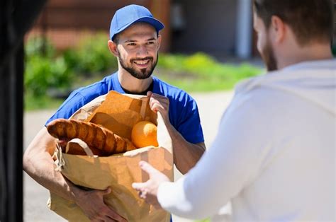 Premium Photo Portrait Of Delivery Man Handing Out Groceries