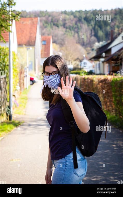 Teenage girl on her way to school, wearing face mask Stock Photo - Alamy