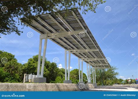 Solar Panels Installed As Shade Roof Over Parking Lot For Parked