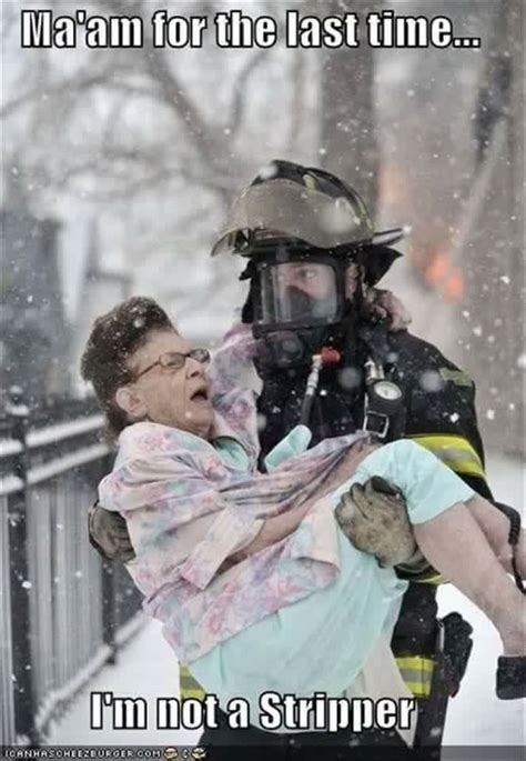 a firefighter holding a woman in the snow