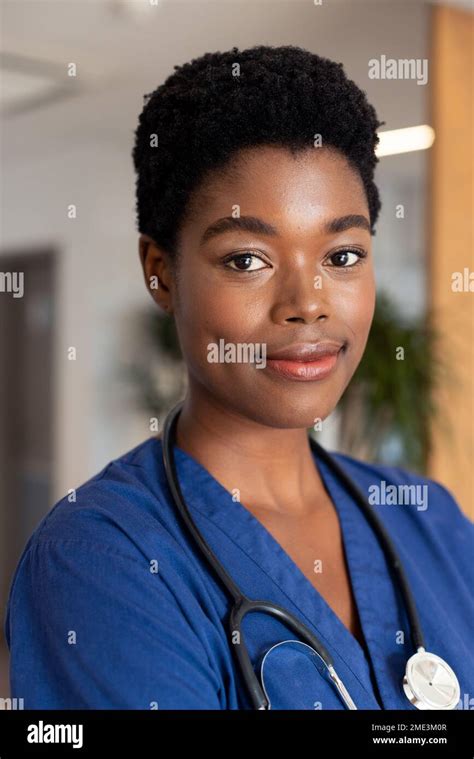 Vertical Portrait Of Smiling African American Female Doctor In Hospital