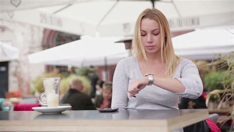 Impatient Woman Waiting And Checking Time On Her Watch Sitting At Train