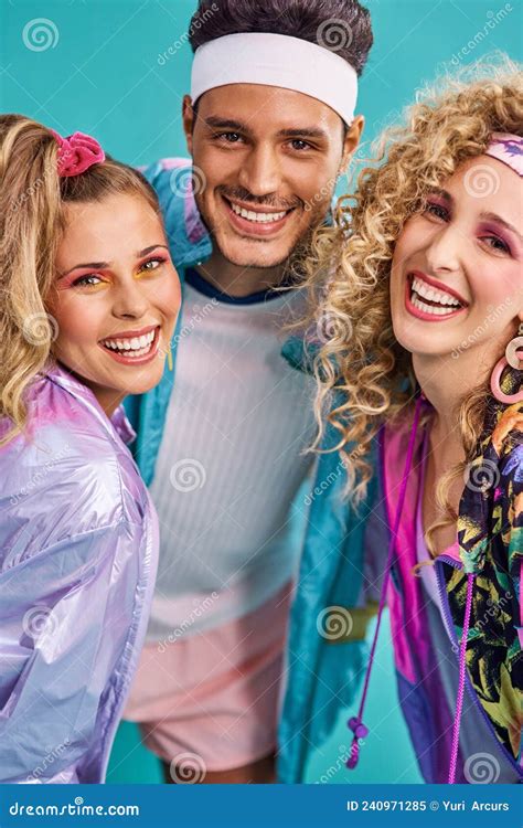 Ready For Some 80s Fun Shot Of Three Young People Posing Together In 80s Clothing Against A