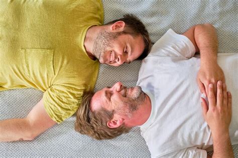 Premium Photo Shot From Above Of Gay Couple Lying In Bed Smiling With Heads Almost Together
