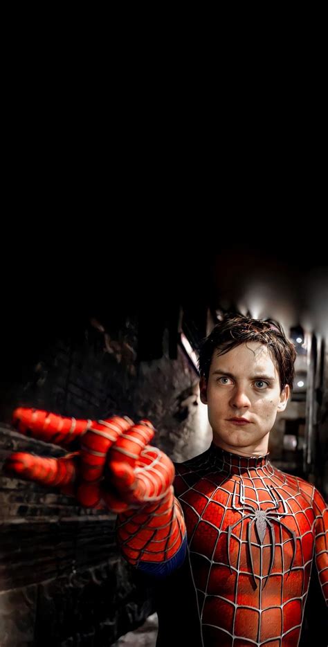 a man dressed as spider - man holding his hands out in front of the camera