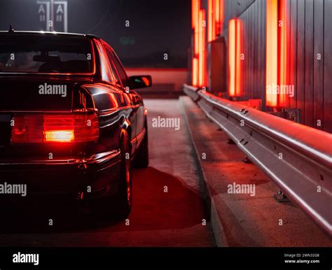 Black Mercedes Benz Sec Coupe At Night Near The Neon Wall Rear Reight Side View Of 1980s