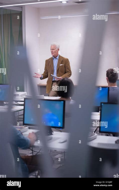Handsome Mature Teacher And Students In Computer Lab Classroom Stock Photo Alamy