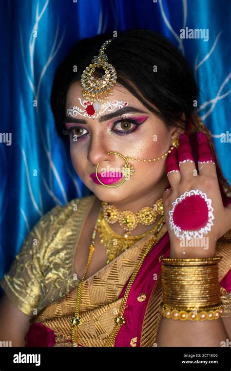 Portrait of a cute Indian model in Bridal look with heavy gold jewelry ...