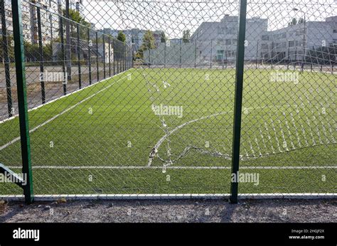 Lawn Field For Playing Football Behind The Green Fence Mesh Close Up