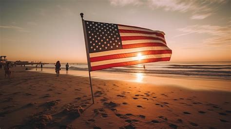 Premium AI Image | An american flag on the beach at sunset