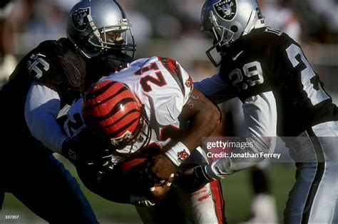 Eric Bieniemy Of The Cincinnati Bengals Is Tackled By Pat Swilling