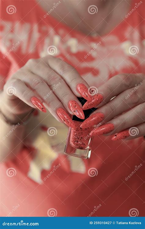 Female Hands With Long Nails And Neon Pink Coral Manicure Stock Image