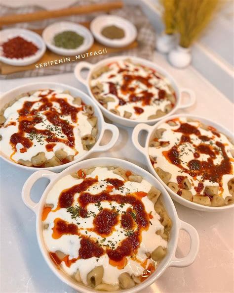 Four Small White Dishes Filled With Food On Top Of A Table