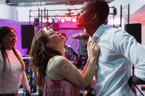 Passionate man and woman dancing and celebrating at nightlife party