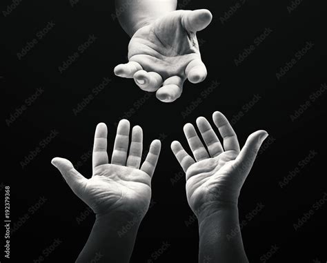 International human rights day concept: Black and white child reaching two hand to God on dark ...