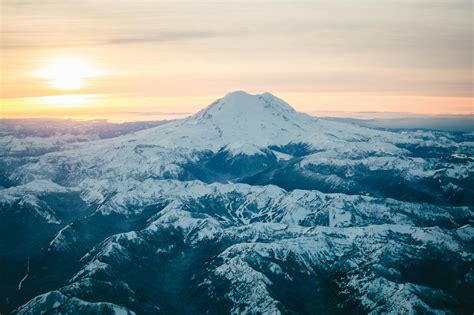 Black Mountain Covered In Snow During Sunset · Free Stock Photo