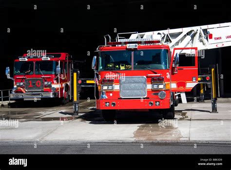 Two Fire Trucks Parked In The Bay With All Of The Fire Fighting