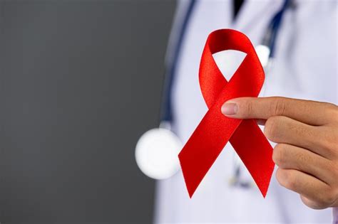 Free Photo The Doctor Holds A Red Ribbon Hiv Awareness Awareness