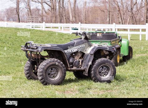 Arctic Cat ATV with John Deere Gator in background on field Stock Photo ...