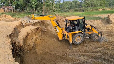 Jcb Backhoe Loader Cutting Soil And Loading In Dump Truck Dump Truck