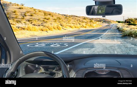 Looking Through A Car Windshield With View Of The Historic Route 66 With Pavement Sign In