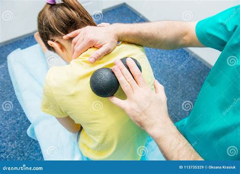 Woman At The Physiotherapy Receiving Ball Massage From Therapist A