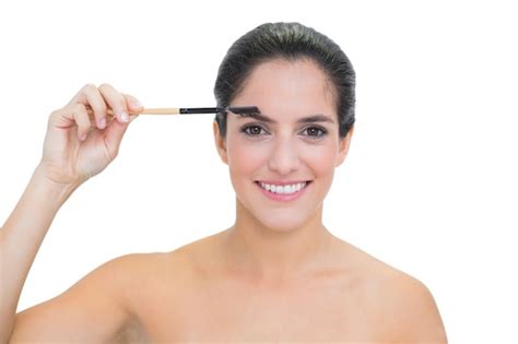 Premium Photo Smiling Bare Brunette Using Eyebrow Brush