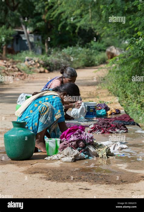 Indian Women Washing Clothes By Hand On A Rural Village Road Andhra