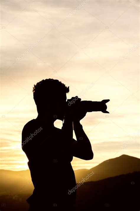 Silhouette of a photographer shooting at sunset — Stock Photo ...