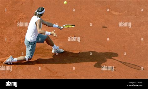 Spanish Tennis Pro Rafael Nadal Hits A Backhand Shot In His Quarter Final Match Against