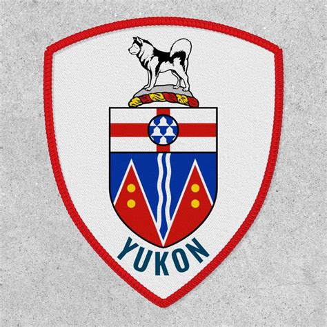 the emblem for yukon is shown in red, white and blue on a gray background