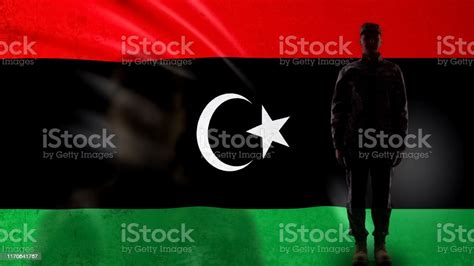 Libyan Soldier Silhouette Standing Against National Flag Proud Army