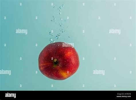 Beautiful View Of Red Apple Falling Into Water On Background Gorgeous