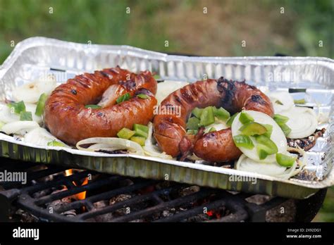 Grilling Bratwurst Sausages Over Flaming Grill Bearbeque Outdoors