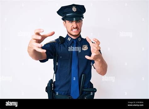 young caucasian man wearing police uniform shouting frustrated
