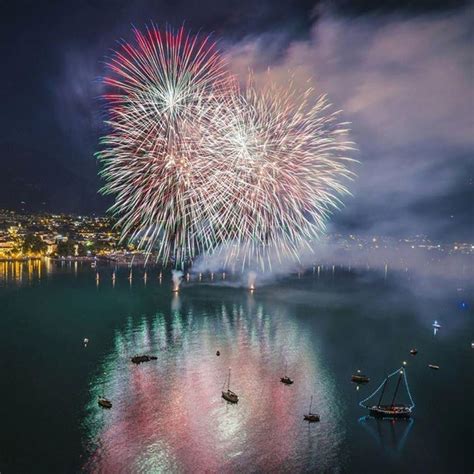 Fireworks Are Lit Up In The Sky Over Water