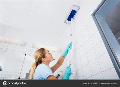 Woman Cleaning Ceiling — Stock Photo © AndreyPopov #137857232