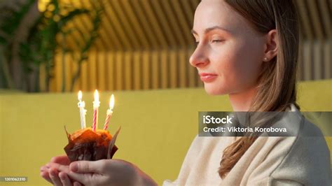 Woman Makes A Wish Blows Out The Candles On A Birthday Cake And Laughs