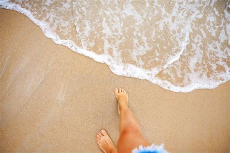 A Beautiful Girl In A Bikini On A Wild Beach Bathing In The Clear Waves Of The Warm Sea A