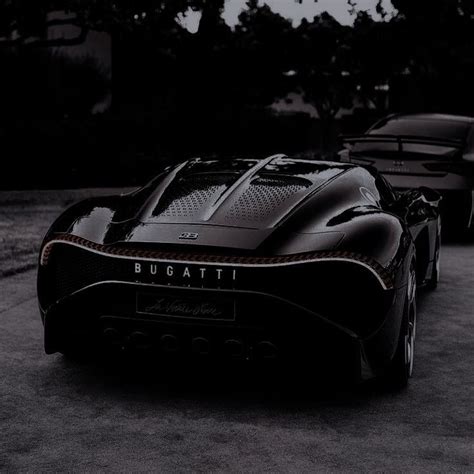 Two Black Sports Cars Parked Next To Each Other