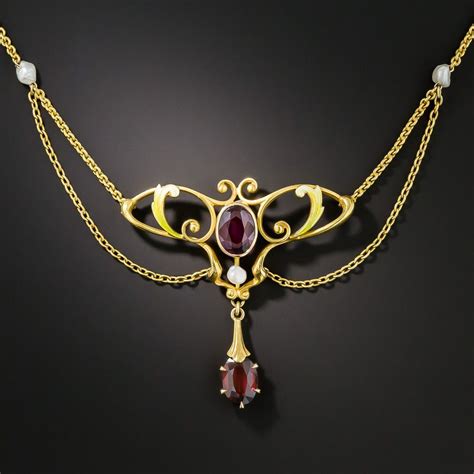 An Enchanting Pair Of Dusky Raspberry Red Garnets Are Featured In This