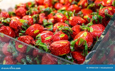 Strawberry Shaped Wrapped Candies In Glass Container Stock Photo