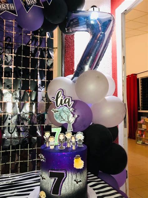 A Birthday Cake With Balloons And Decorations